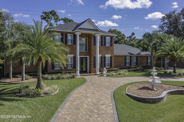 8135 Wekiva Way, Jacksonville, FL 32256 - greek revival inspired property featuring a front yard, brick siding, and roof with shingles