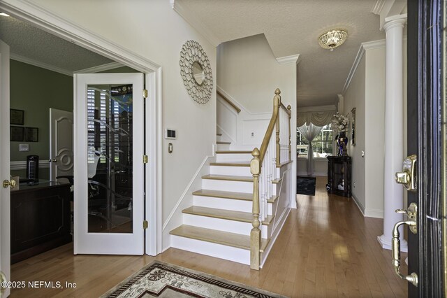 8135 Wekiva Way, Jacksonville, FL 32256 - foyer with ornamental molding, wood finished floors, stairway, a textured ceiling, and baseboards
