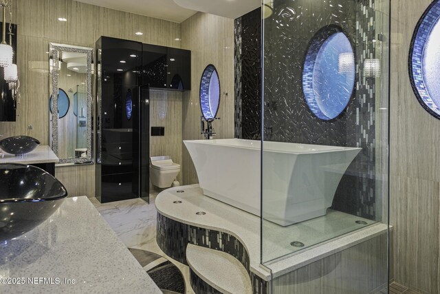 8135 Wekiva Way, Jacksonville, FL 32256 - full bathroom with a freestanding tub, vanity, marble tiled floors, and toilet