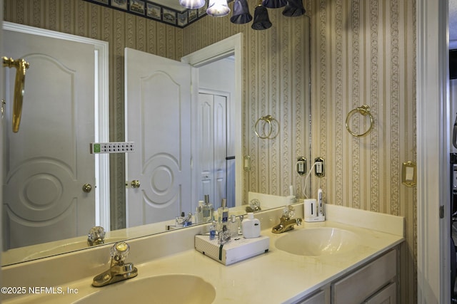 8135 Wekiva Way, Jacksonville, FL 32256 - bathroom featuring wallpapered walls, double vanity, and a chandelier