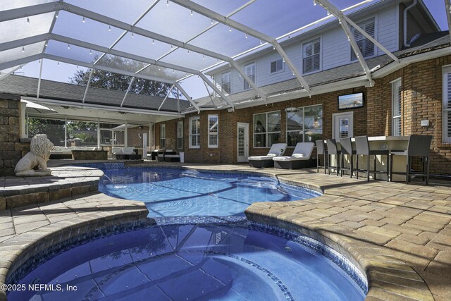 8135 Wekiva Way, Jacksonville, FL 32256 - view of pool featuring a patio area, a pool with connected hot tub, and glass enclosure