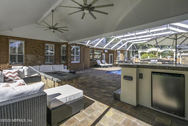 8135 Wekiva Way, Jacksonville, FL 32256 - view of patio / terrace with an outdoor kitchen, outdoor lounge area, a ceiling fan, and glass enclosure