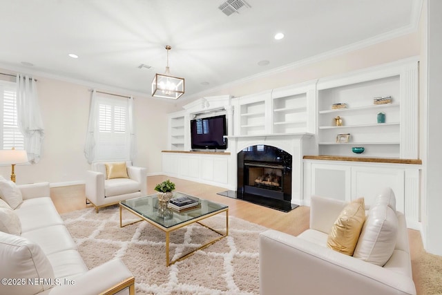 8135 Wekiva Way, Jacksonville, FL 32256 - living room with crown molding, light wood-style flooring, a chandelier, recessed lighting, and a premium fireplace
