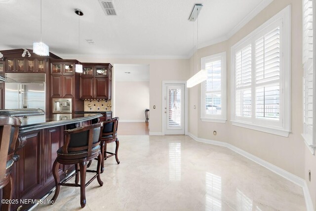 8135 Wekiva Way, Jacksonville, FL 32256 - kitchen featuring stainless steel built in refrigerator, crown molding, decorative light fixtures, glass insert cabinets, and backsplash