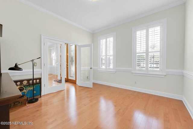 8135 Wekiva Way, Jacksonville, FL 32256 - unfurnished room with french doors, wood finished floors, ornamental molding, and baseboards