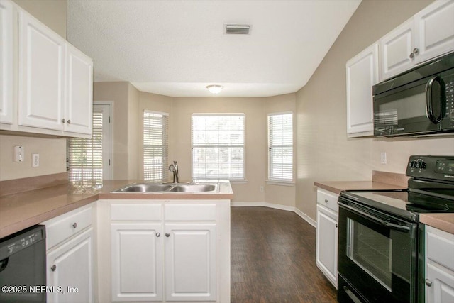 12142 Corner Oaks Dr, Jacksonville, FL 32223 - kitchen with black appliances, a sink, a peninsula, and white cabinetry