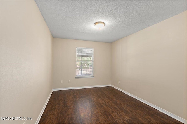 12142 Corner Oaks Dr, Jacksonville, FL 32223 - unfurnished room featuring dark wood-style floors, a textured ceiling, and baseboards