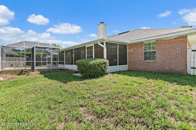 12142 Corner Oaks Dr, Jacksonville, FL 32223 - back of property featuring a sunroom, a chimney, and brick siding