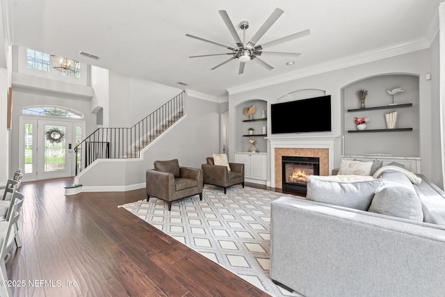 1612 Inkberry Ln, Saint Johns, FL 32259 - living area featuring stairs, wood finished floors, built in shelves, a fireplace, and a ceiling fan