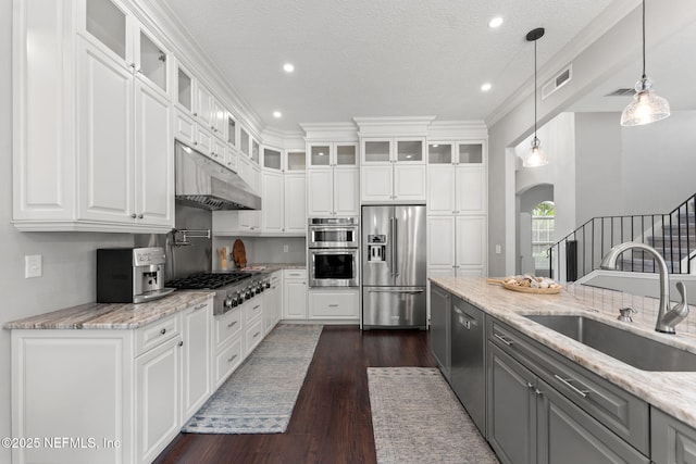 1612 Inkberry Ln, Saint Johns, FL 32259 - kitchen featuring appliances with stainless steel finishes, arched walkways, under cabinet range hood, gray cabinets, and white cabinetry