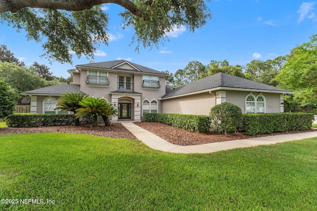 1612 Inkberry Ln, Saint Johns, FL 32259 - view of front of home featuring stucco siding, a front yard, and a shingled roof