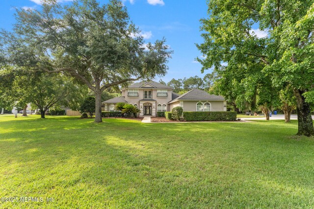 1612 Inkberry Ln, Saint Johns, FL 32259 - view of front facade with stucco siding and a front lawn