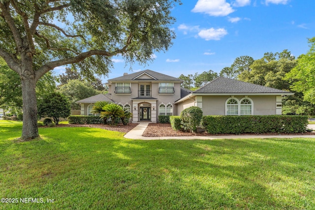 1612 Inkberry Ln, Saint Johns, FL 32259 - traditional-style house featuring stucco siding, a front lawn, and french doors