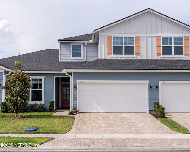 760 Cherry Elm Dr, Saint Augustine, FL 32092 - view of front facade featuring decorative driveway, a garage, a front lawn, board and batten siding, and roof with shingles