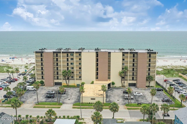 601 1st St Unit 4H, Jacksonville Beach, FL 32250 - view of apartment building / complex featuring uncovered parking and view of water and beach