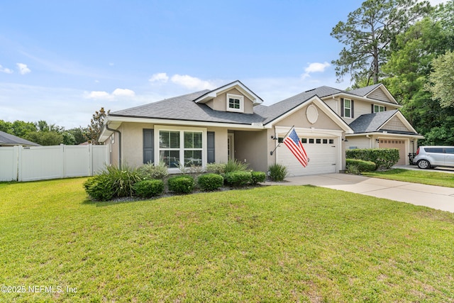 11521 Dunforth Cove Dr, Jacksonville, FL 32218 - view of front of home with a garage, stucco siding, concrete driveway, and a shingled roof