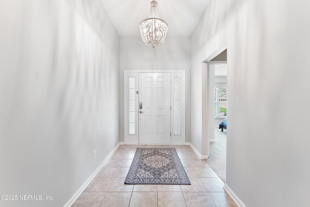 11521 Dunforth Cove Dr, Jacksonville, FL 32218 - foyer with light tile patterned flooring, a chandelier, and baseboards