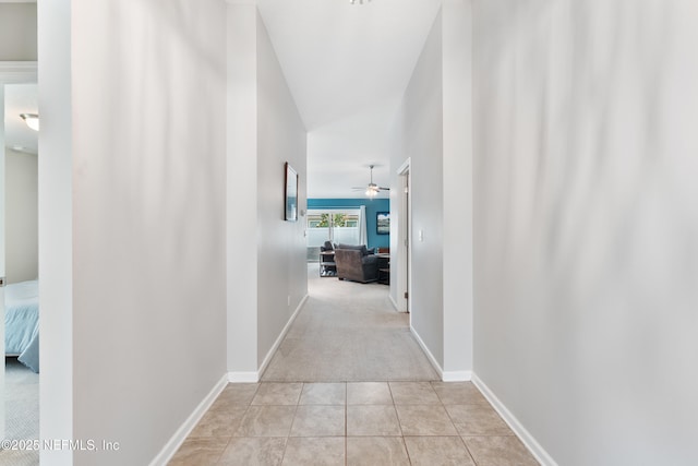 11521 Dunforth Cove Dr, Jacksonville, FL 32218 - hallway featuring light colored carpet, light tile patterned floors, and baseboards
