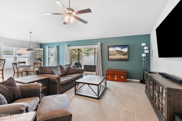 11521 Dunforth Cove Dr, Jacksonville, FL 32218 - living area with a ceiling fan, healthy amount of natural light, lofted ceiling, light colored carpet, and baseboards