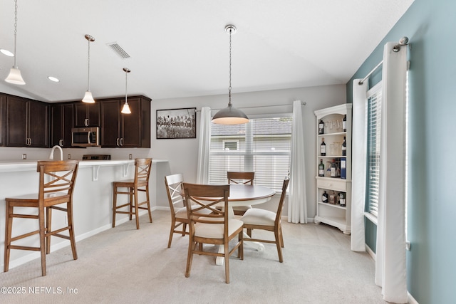 11521 Dunforth Cove Dr, Jacksonville, FL 32218 - dining area with light carpet, baseboards, and vaulted ceiling