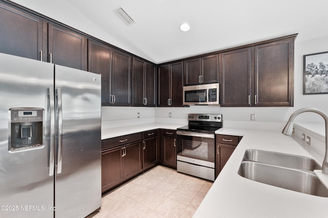 11521 Dunforth Cove Dr, Jacksonville, FL 32218 - kitchen with stainless steel appliances, a sink, light countertops, dark brown cabinets, and lofted ceiling
