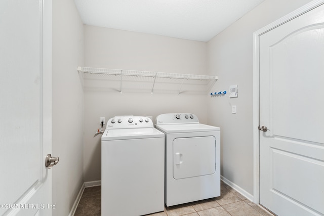 11521 Dunforth Cove Dr, Jacksonville, FL 32218 - laundry area featuring washing machine and dryer, baseboards, and light tile patterned floors