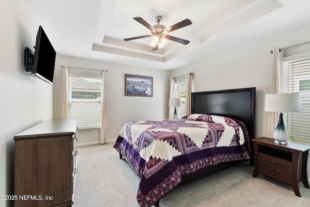 11521 Dunforth Cove Dr, Jacksonville, FL 32218 - bedroom featuring light carpet, a raised ceiling, multiple windows, and ceiling fan