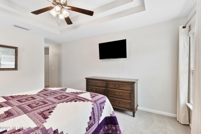 11521 Dunforth Cove Dr, Jacksonville, FL 32218 - bedroom featuring light carpet, a tray ceiling, baseboards, and a ceiling fan