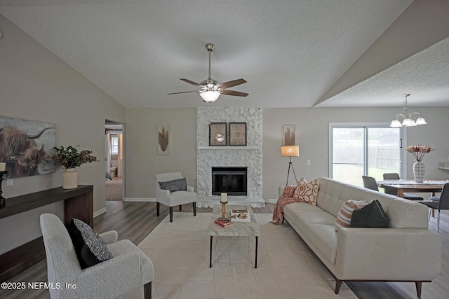 1798 Shannon Lake Dr, Middleburg, FL 32068 - living room with vaulted ceiling, light wood finished floors, ceiling fan, a chandelier, and a large fireplace