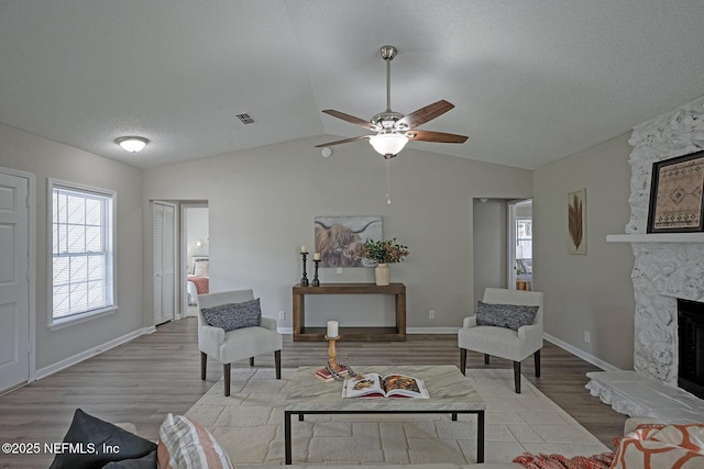 1798 Shannon Lake Dr, Middleburg, FL 32068 - living area featuring wood finished floors, ceiling fan, a textured ceiling, a fireplace, and lofted ceiling