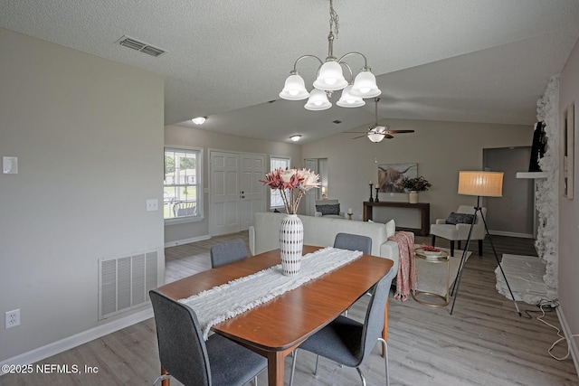 1798 Shannon Lake Dr, Middleburg, FL 32068 - dining area with light wood-style flooring, a chandelier, vaulted ceiling, ceiling fan, and baseboards