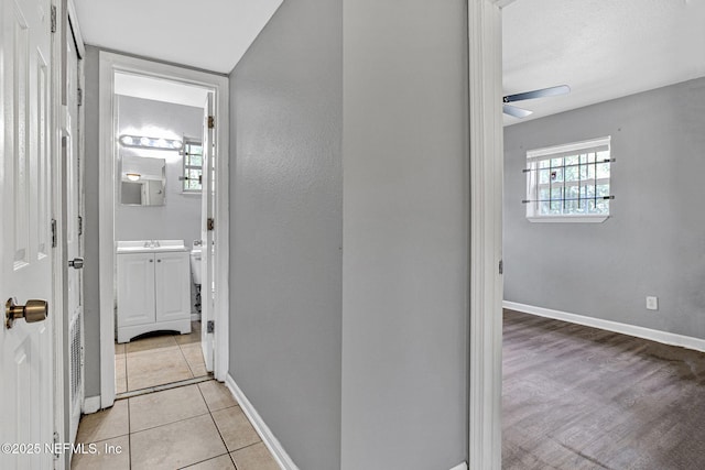 9118 Devonshire Blvd, Jacksonville, FL 32208 - hallway featuring baseboards and light tile patterned floors