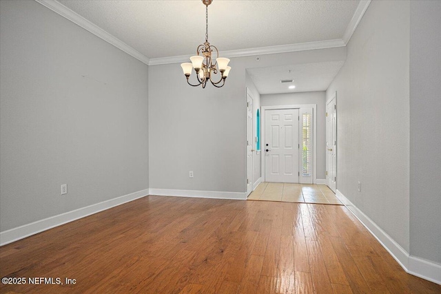 215 S Ocean Grande Dr Unit 105, Ponte Vedra Beach, FL 32082 - foyer with a chandelier, light wood-style flooring, baseboards, and ornamental molding