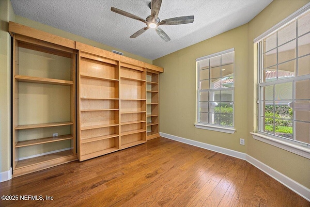 215 S Ocean Grande Dr Unit 105, Ponte Vedra Beach, FL 32082 - unfurnished bedroom with baseboards, wood finished floors, and a textured ceiling