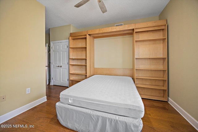 215 S Ocean Grande Dr Unit 105, Ponte Vedra Beach, FL 32082 - bedroom featuring baseboards, dark wood-style flooring, ceiling fan, and a textured ceiling