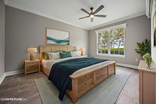 215 S Ocean Grande Dr Unit 105, Ponte Vedra Beach, FL 32082 - bedroom featuring crown molding, a textured ceiling, wood finished floors, baseboards, and ceiling fan