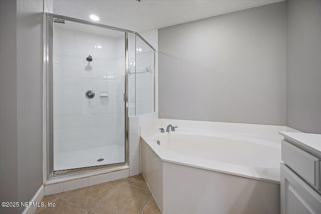 215 S Ocean Grande Dr Unit 105, Ponte Vedra Beach, FL 32082 - bathroom with a stall shower, a bath, tile patterned floors, and vanity