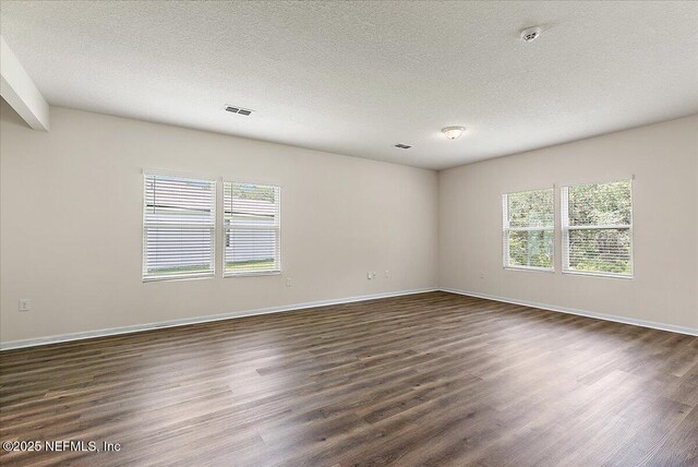 187 Logrono Ct, Saint Augustine, FL 32084 - empty room with dark wood-style floors, a textured ceiling, and baseboards