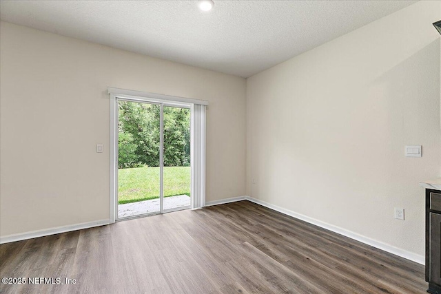 187 Logrono Ct, Saint Augustine, FL 32084 - empty room with dark wood-style floors, baseboards, and a textured ceiling