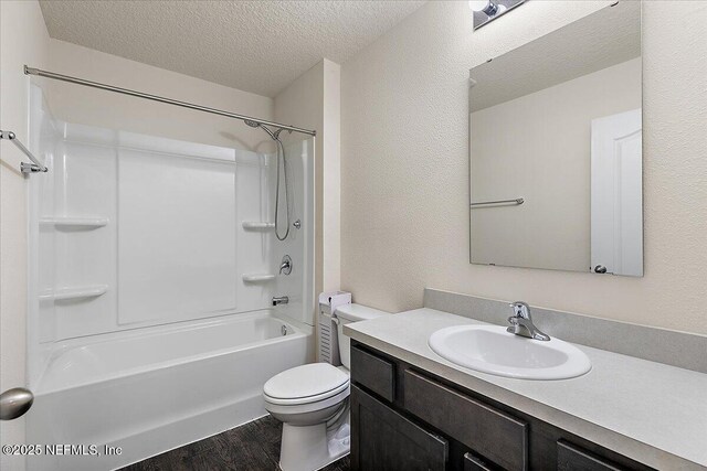 187 Logrono Ct, Saint Augustine, FL 32084 - bathroom featuring a textured ceiling, vanity, toilet, wood finished floors, and shower / bath combination