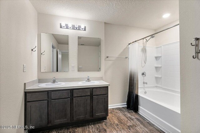 187 Logrono Ct, Saint Augustine, FL 32084 - full bath with a textured wall, wood finished floors, a textured ceiling, shower / bath combo, and double vanity