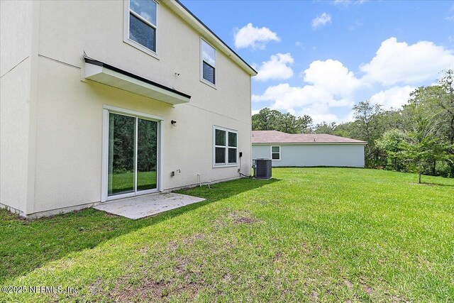 187 Logrono Ct, Saint Augustine, FL 32084 - back of property with a lawn, stucco siding, and cooling unit