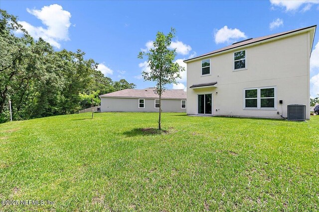 187 Logrono Ct, Saint Augustine, FL 32084 - back of property featuring stucco siding, a yard, and central AC