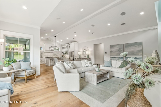 22 N 17th St, Amelia Island, FL 32034 - living area with lofted ceiling, light wood-type flooring, recessed lighting, and crown molding
