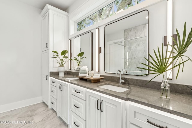 22 N 17th St, Amelia Island, FL 32034 - full bathroom with double vanity, a stall shower, baseboards, and marble look tiles