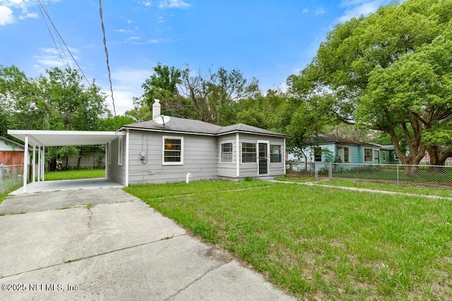 937 Stark St, Jacksonville, FL 32208 - view of front facade with driveway, a chimney, and an attached carport