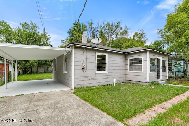 937 Stark St, Jacksonville, FL 32208 - view of front of house with a carport, driveway, and a chimney