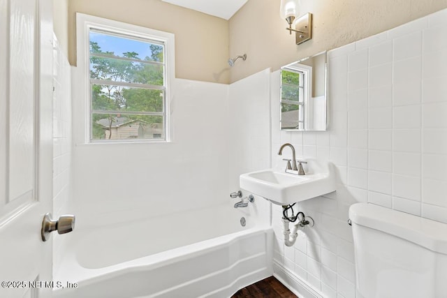 937 Stark St, Jacksonville, FL 32208 - full bathroom featuring tile walls, toilet, bathtub / shower combination, plenty of natural light, and a sink