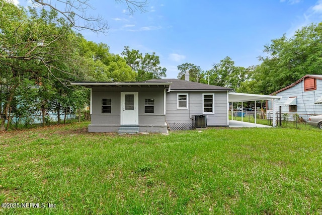 937 Stark St, Jacksonville, FL 32208 - back of house featuring central AC unit and a carport