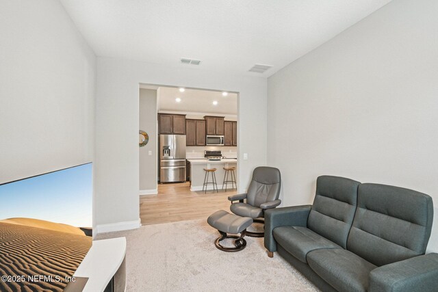 285 Greenway Ln, Saint Augustine, FL 32092 - living area featuring light carpet, baseboards, and recessed lighting